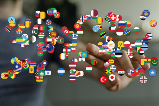 Hand holding a collection of country flags, representing global connections and diversity. Global concept symbolizing unity and international co