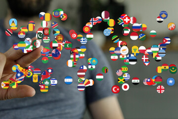 Hand reaching towards a collection of national flags, representing global connections, unity, and international concepts. Perfect for travel and