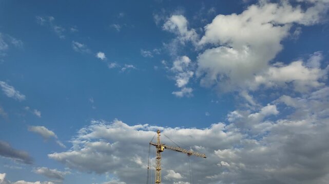 Timelapse of an industrial construction crane with cloudy background