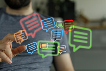 A man interacting with a holographic chat bubble interface symbolizing digital communication and information sharing on the internet.