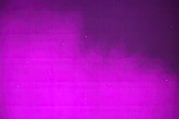 Blurred magenta gradient background with small white dust specks
