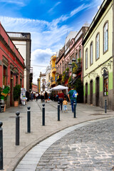 Colorful Old Town Street in Arucas, Gran Canaria. Families and visitors stroll past cafés and small shops