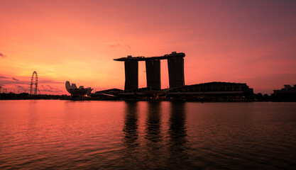 Silhouette image of Singapore Skyline and view of skyscrapers on Marina Bay at sunrise.