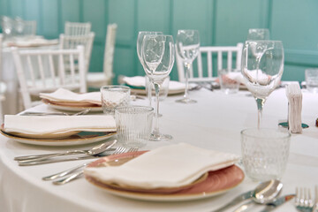 Elegant Dining Setting Featuring Tableware and Glasses Ready for a Special Occasion with Soft Lighting and Tasteful Decor