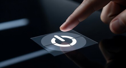 Finger pushing power button on glossy dark surface for technology concept