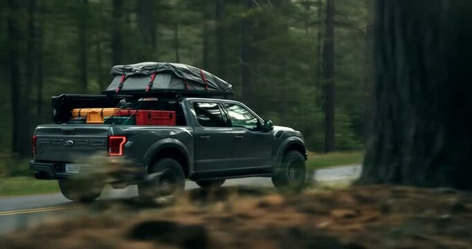 Pickup truck driving through a forested road with gear