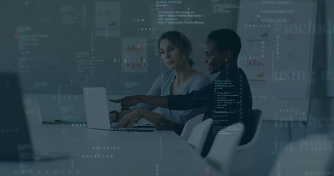Pointing at laptop screen African American woman and White colleague collaborating in meeting room