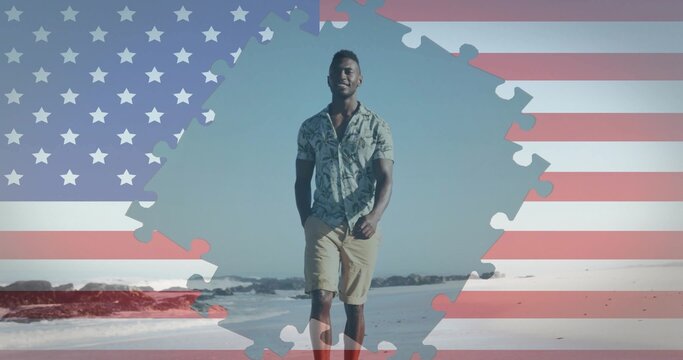 Walking man wearing casual outfit on sandy beach, with jigsaw puzzle piece and flag motif overlay
