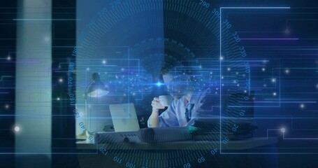 Naklejka premium Holding coffee cup, man in shirt analyzing laptop screen under lamp in office, with digital overlay