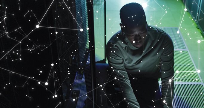 Kneeling network engineer connecting cables in data center, with server racks and network overlay - Powered by Adobe