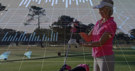 Senior golfer adjusting club grip on golf fairway, with bag, glove, visor, overlays, copy space