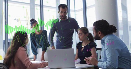 Colleagues reviewing laptop data in glass-walled office, with notebooks  and  pens, data overlays