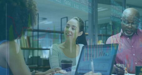 Collaborating professionals analyzing financial charts around table in meeting room, with laptop