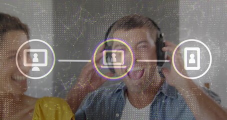 Adjusting over-ear headphones man singing at studio with woman in yellow top, digital network icons