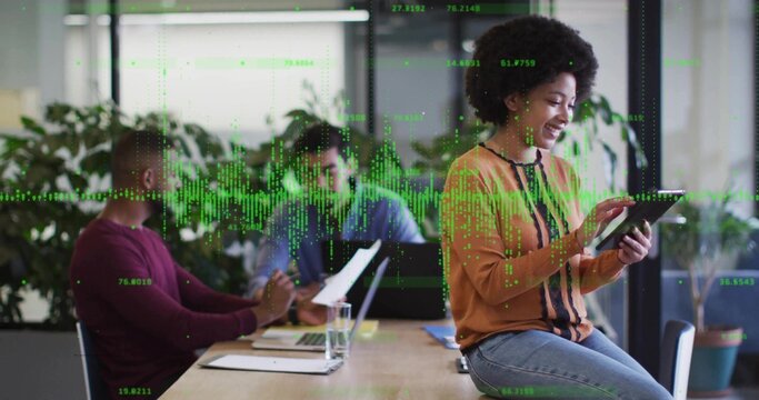 Using tablet, Black female worker consulting data in meeting room, with digital data overlay - Powered by Adobe