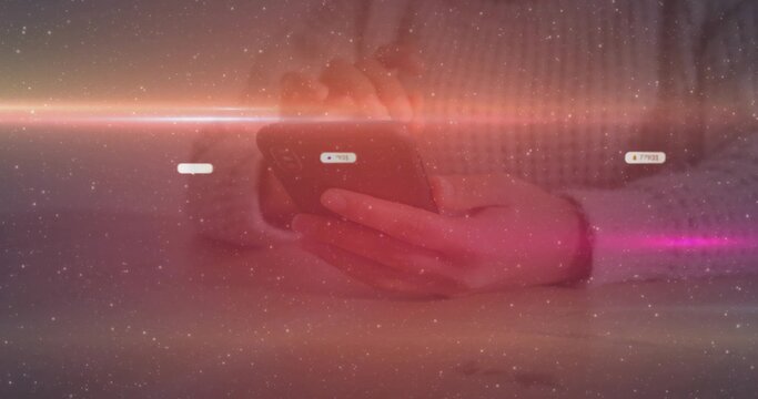 Holding smartphone woman in knit sweater scrolling at home table, with annotations and lens flare