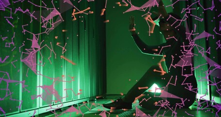 Korean man kneeling, analyzing holographic network in LED server hall with grated floor, copy space