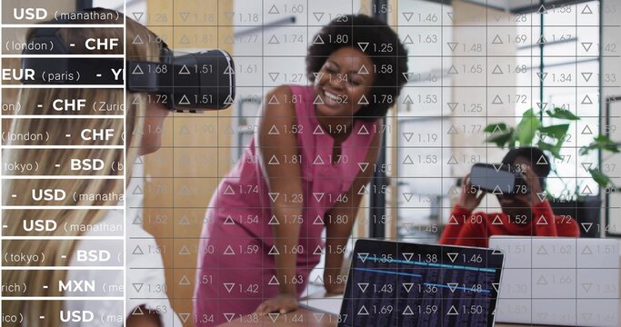 Smiling businesswoman leaning on modern office table, with colleagues using laptop and VR headset