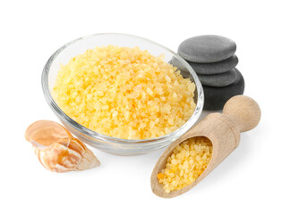 Yellow sea salt in bowl, scoop, spa stones and shell isolated on white