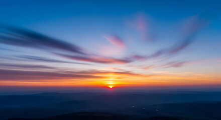 Fototapeta premium A breathtaking view of the horizon at sunset with vibrant colors and wispy clouds in the sky above ai generated