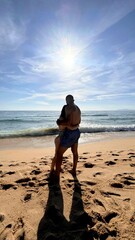 Inlove couple looking at the ocean. Romantic picture of a couple. Beach day on vacation. hugging couple. romantic picture. Beach destination in Europe. 