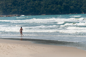 young woman walking on the beach