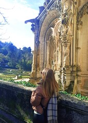 Perfect for luxury travel, European heritage stock. Charming young womanI admiring the Bussaco Palace Hotel, Portugal. Tall Gothic towers. Perfect for travel, European history stock. travel blog 