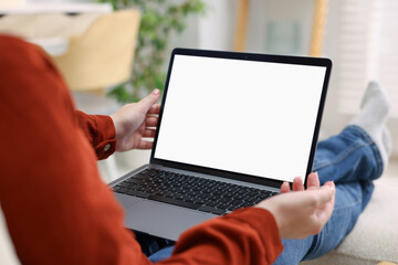 Woman working with laptop indoors, closeup. Mockup for design