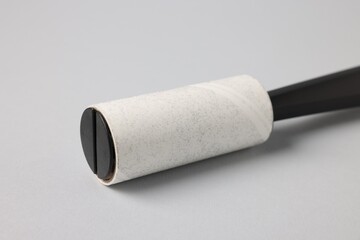 One lint roller on light grey background, closeup