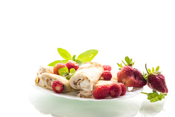 Plate with pancakes and fresh strawberries on white