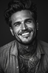 Obraz premium black and white portrait of smiling tattooed man in open shirt with styled hair and high contrast lighting emphasizing facial features and textures