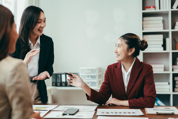 Asian businesswomen engaging in a collaborative discussion about marketing strategies during a productive office meeting