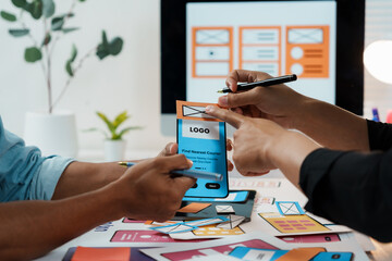 Two designers engaging in a discussion about user interface and user experience for a mobile app during a collaborative meeting