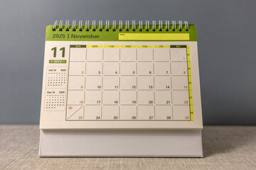 Hello, November 2025. A desktop calendar for planning on the table.