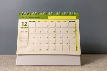 Hello, December 2025. A desktop calendar for planning on the table.