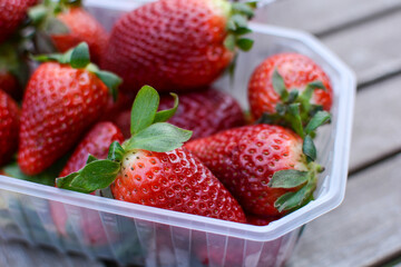Fresh sweet strawberries in a box. strawberry harvest. red strawberries on a wooden table