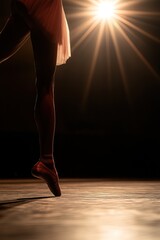 Dancer strikes a graceful pose on stage with focused spotlight