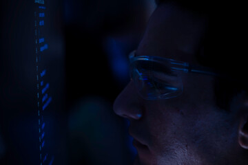 Two software developers collaborating at night, focusing on code review and debugging process on a computer screen, representing teamwork, innovation, and modern software development workflow.