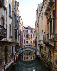 Scenic narrow Venetian canal with reflection and historic houses