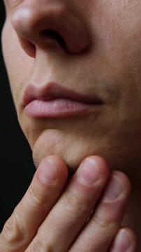 Close-up of young man patchy stubble beard, concept of shaving, grooming, skincare. Vertical Video