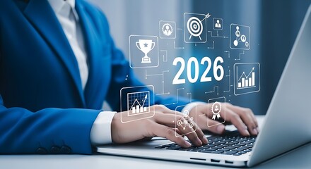 Businessperson typing on laptop with futuristic 2026 graphics overlay