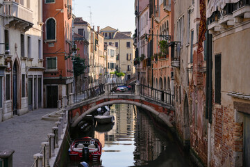 Historic Venetian architecture along small water canal and bridge