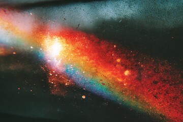 Grainy colorful warm rainbow red light leaks on black background with dust texture. abstract damaged scratched retro film analog effect for using over photos as overlay or screen filter