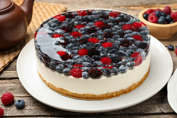 Delicious cheesecake with berries on wooden table, closeup