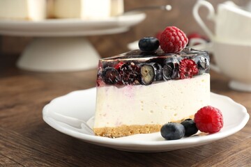 Piece of delicious cheesecake with berries on wooden table, closeup