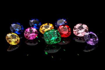 A collection of gemstones in various colors, including green, red, and yellow