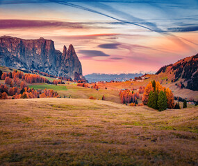 Astonishing autumn view of Alpe di Siusi mountain plateau. Impressive morning scene of Dolomite Alps, Ortisei locattion, Italy. Beauty of nature concept background.