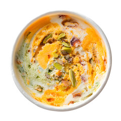 Top view of pistachio and mango ice cream with nuts in a cup. Gourmet Indian Kulfi style frozen dessert isolated on black background.