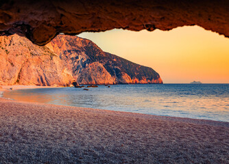 Colorful summer sunset onPorto Katsiki Beach. Amezing evening seascape of Ionian sea. Picturesque outdoor scene of Lefkada Island, Greece, Europe. Vacation concept background.