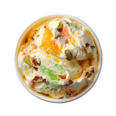 Top view of pistachio and mango ice cream with nuts in a cup. Gourmet Indian Kulfi style frozen dessert isolated on black background.